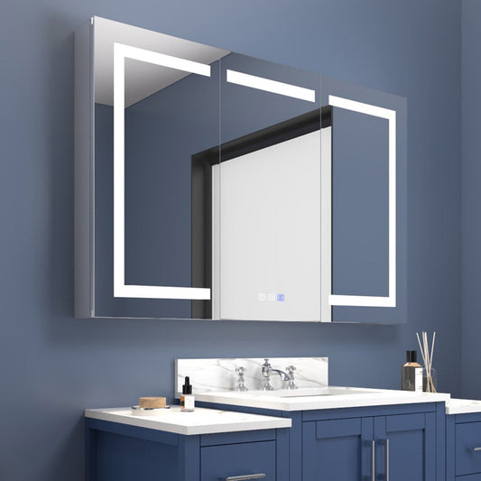 Bathroom vanity with illuminated mirror against a blue wall