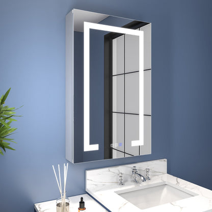Bathroom with a illuminated mirror cabinet and sink against a blue wall.