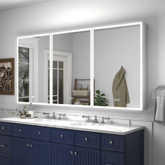 Bathroom with a large illuminated mirror above two sinks with blue cabinets.
