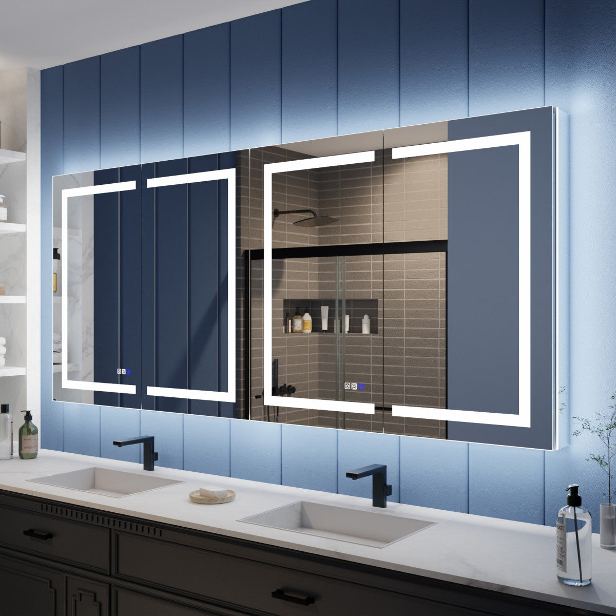 Bathroom vanity with two large illuminated mirrors on a blue paneled wall.