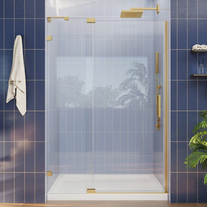 Modern glass shower enclosure with gold fixtures in a bathroom setting.
