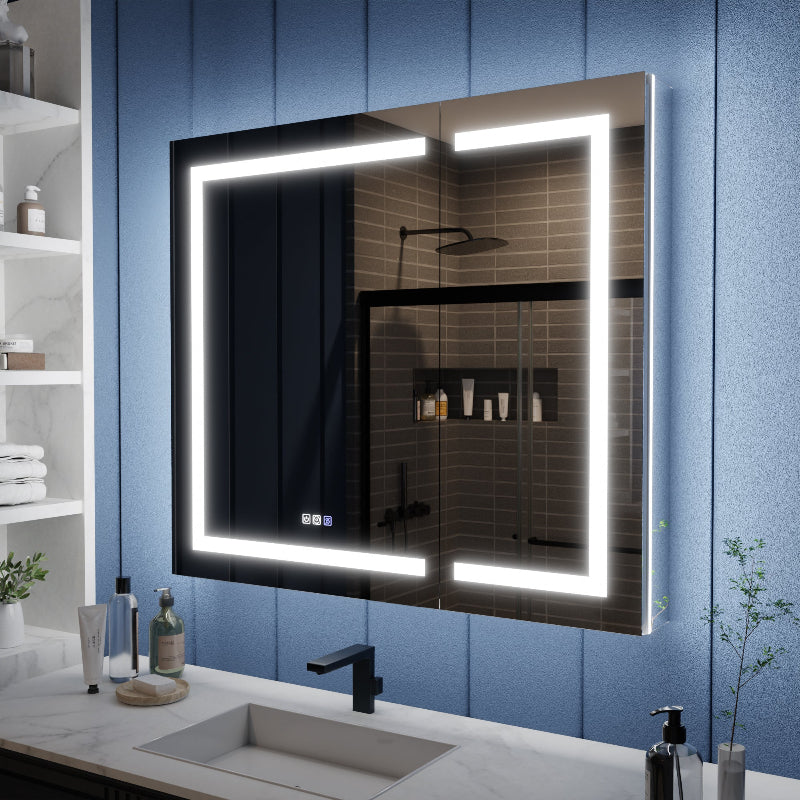 Bathroom with a large illuminated mirror above a sink against a blue wall.