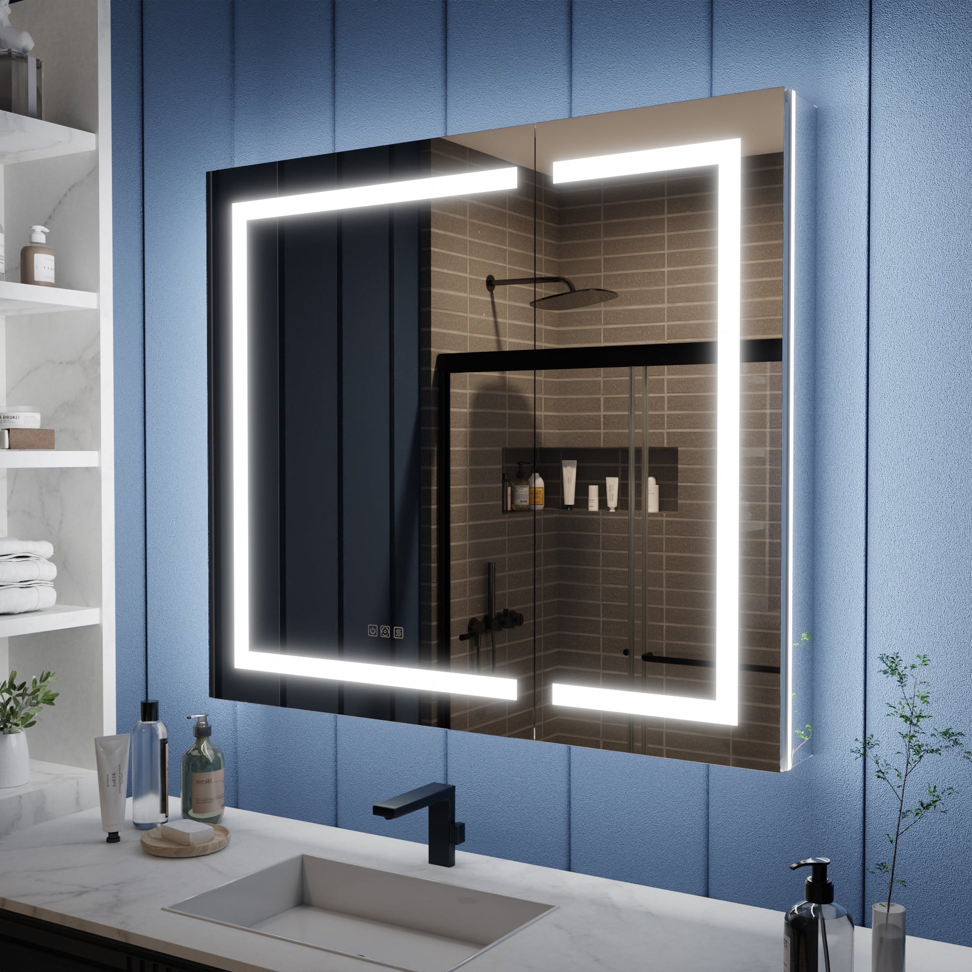 Bathroom with a large illuminated mirror above a sink, against a blue paneled wall.
